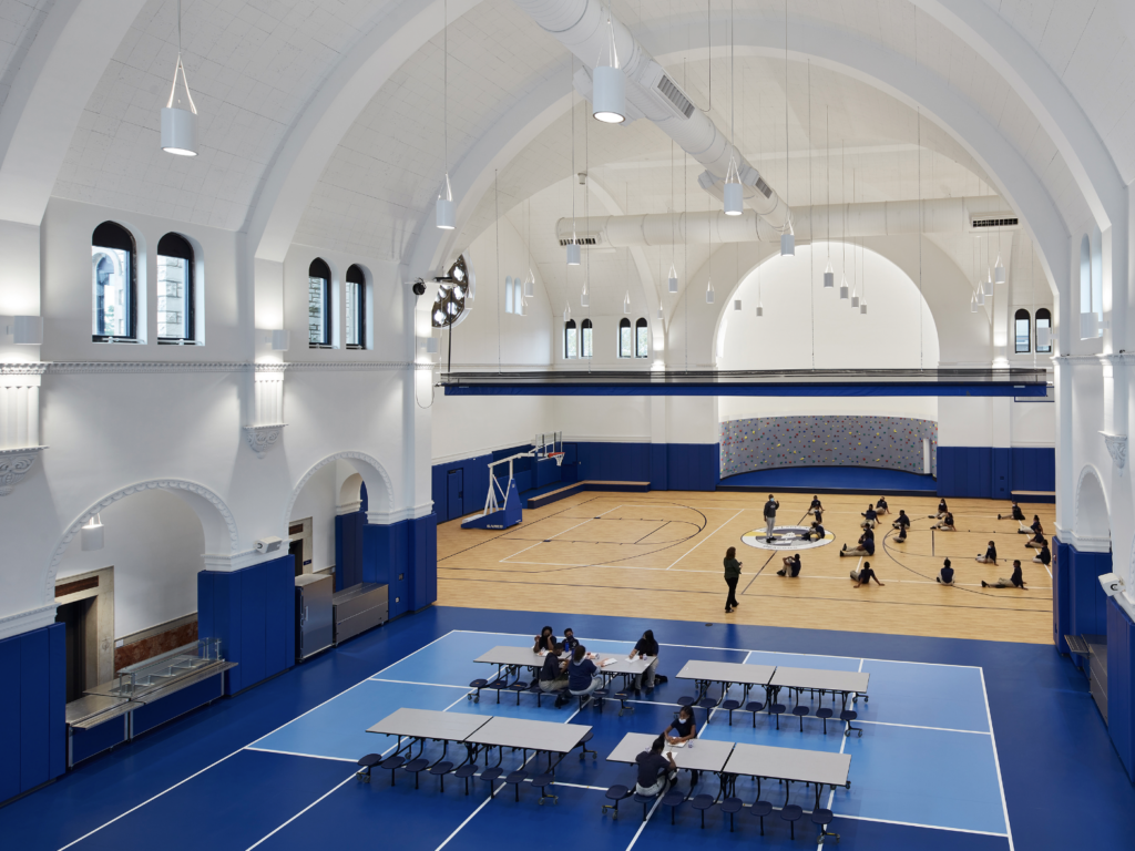 Under the vaulted ceiling of the former church, students now exercise and compete in their new gymnasium. The north side houses the cafeteria, where staff members serve more than 600 healthy breakfasts and lunches each day.