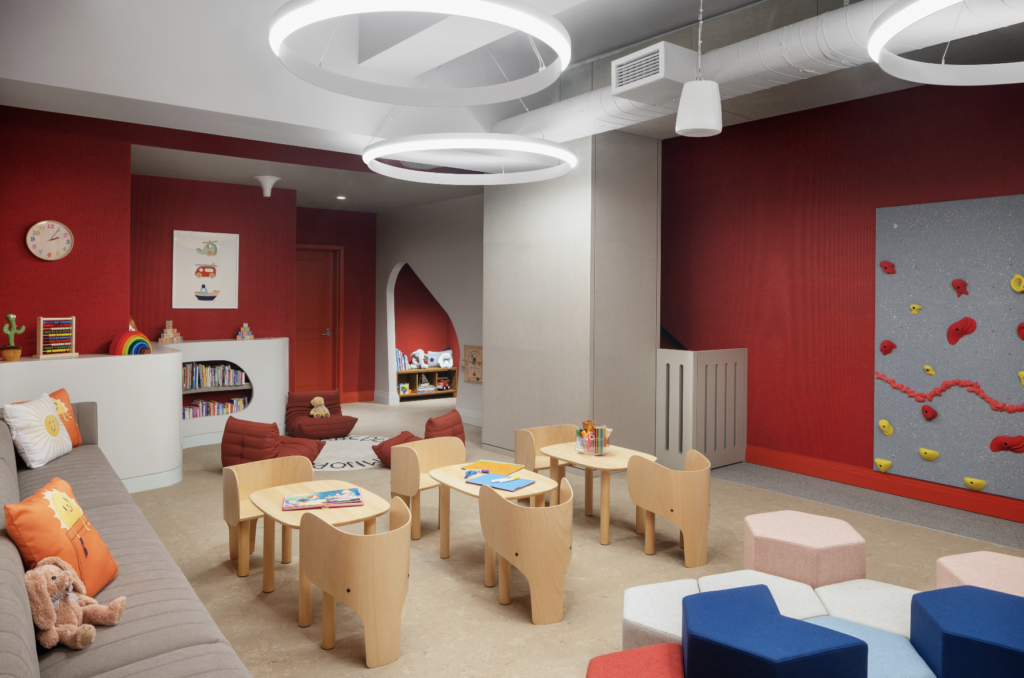 Additional amenities, including a children’s room (seen here), teen room and co-working suite, are intentionally placed throughout the building to allow for diversity of experience and to foster a sense of community.