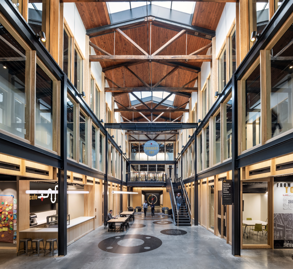 The triple-height atrium, unsympathetically modified with infill floors in the 1980s, was restored to its original volume, which provides visual and physical connection among the workshops.