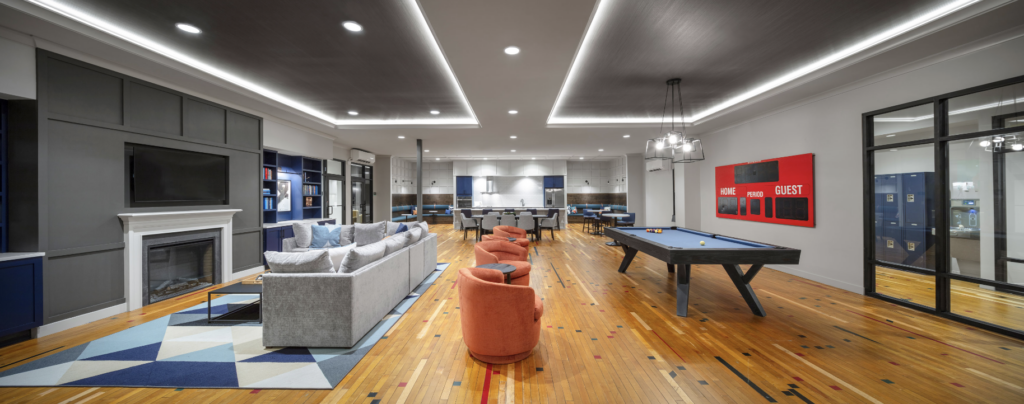 The gym on the second floor was repurposed into resident amenity spaces, with the lounge occupying half of the former gym's floor area. Wood flooring was salvaged and reinstalled, and patches were applied as needed.
