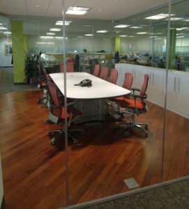 When a New Jersey company transformed more than 10,000 square feet of old-style office space to conserve energy and improve productivity, one key was to retrofit the underfloor duct system to support power, data and communications in open spaces and this glassed-in conference room. Duct activations can be seen in the foreground and under the conference table.