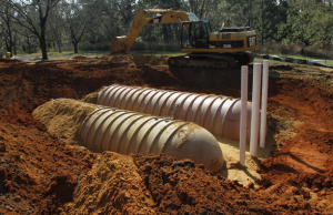 A series of 60 vertical well loops extending 90-feet deep into the ground recirculates water through buried small-diameter HDPE pipes. The geothermal system uses heat from the ground and underlying Floridian aquifer to provide a stable supply of 68 F water to the facility.