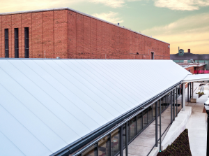 EXTECH’s SKYSHADE 8000 is a long-spanning standing-seam canopy system that offers continuous battens that rigidly clamp over structural cellular polycarbonate glazing (CPG).