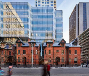 The architects juxtaposed the new architecture against the old. The 9-story tower is clad in curving glass, floating above a restored base of Victorian rowhouses.  